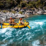 A group of people riding on the back of a raft